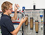 Employee fills samples on test columns filled with sand